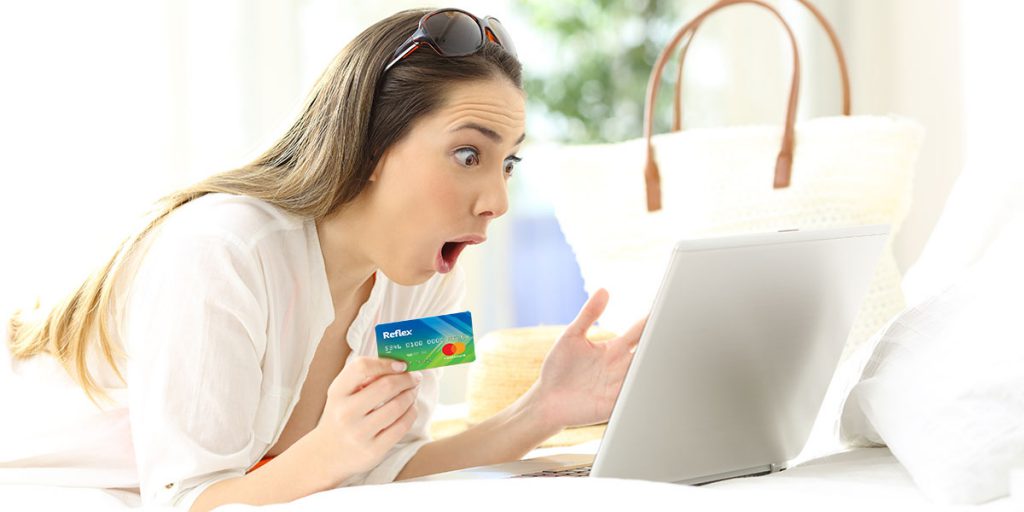 Woman looking at laptop for best credit cards for bad credit shows surprise at credit card approval