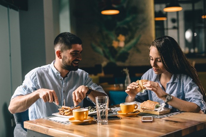 Two people eating in a restaurant. 