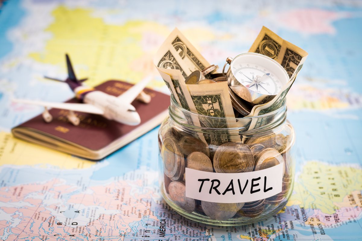 Travelling on a Budget blog: Picture of plane passport map and jar full of money. labeled travel