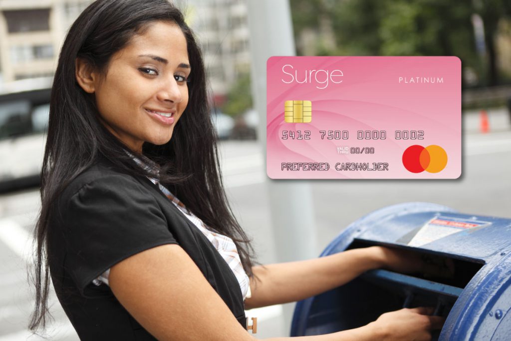 Woman at the mailbox and a Surge Mastercard. Learn how to pay your credit card bill by mail.